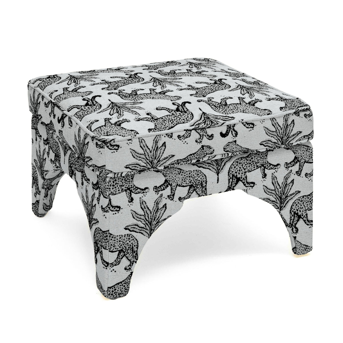 Upholstered ottoman in white with black jungle animal print, padded top, short turned legs