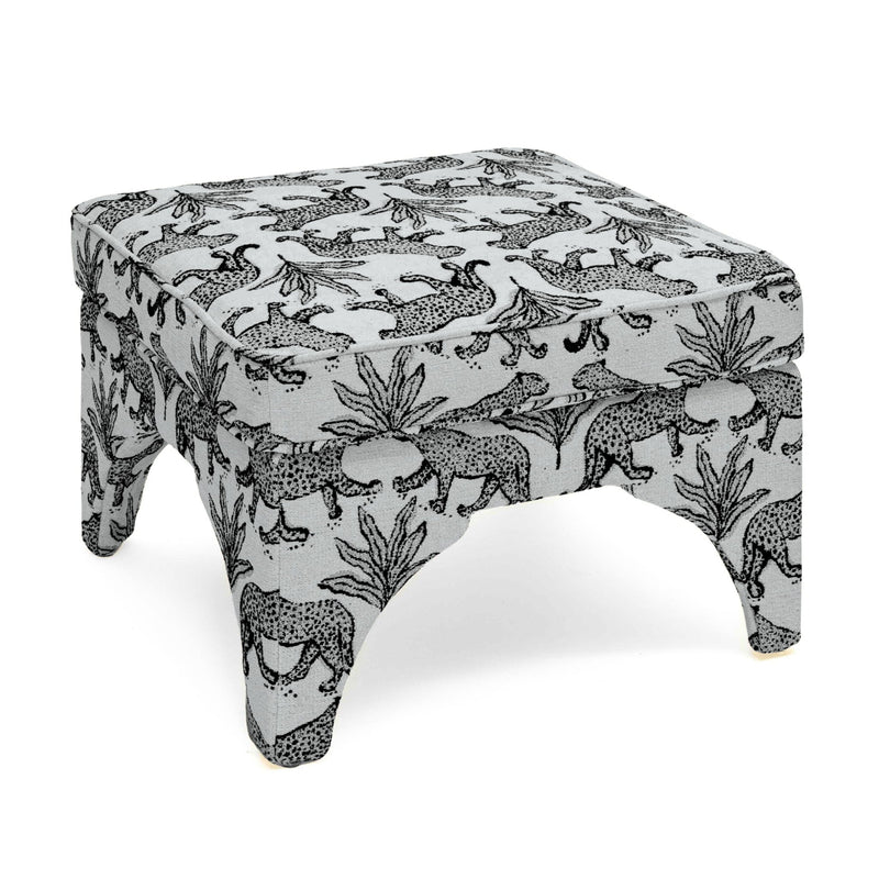 Upholstered ottoman in white with black jungle animal print, padded top, short turned legs