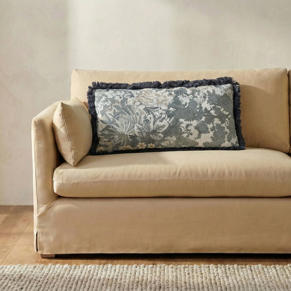 Blue and gray tapestry lumbar cushion with dark fringe and botanical floral pattern