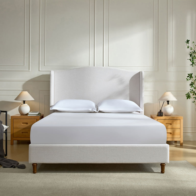 Beige upholstered king wingback bed with tall headboard and low-profile frame