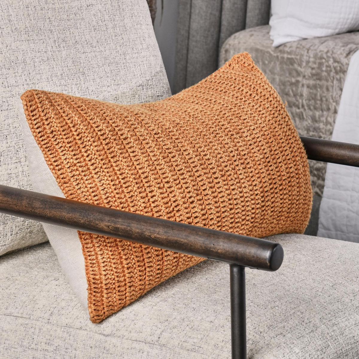 Saffron orange knit throw pillow with triangular shape and chunky woven texture
