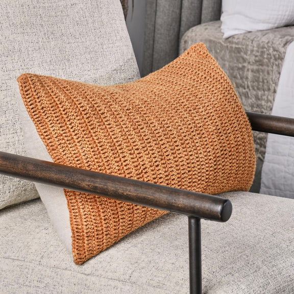 Saffron orange knit throw pillow with triangular shape and chunky woven texture