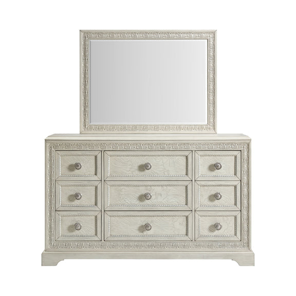 White dresser with mirror featuring three rows of drawers and round silver knobs.