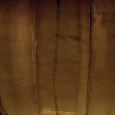 Amber glass lamp with textured panels and vertical ridges
