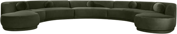 Dark green velvet sectional sofa with rounded, button-tufted seat cushions.