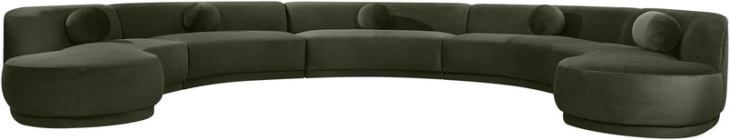 Dark green velvet sectional sofa with rounded, button-tufted seat cushions.