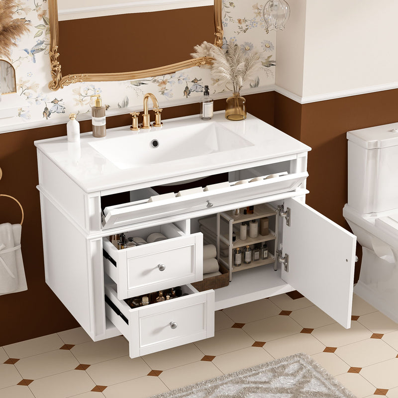 White vanity with sink and open drawers and cabinet door showing storage.