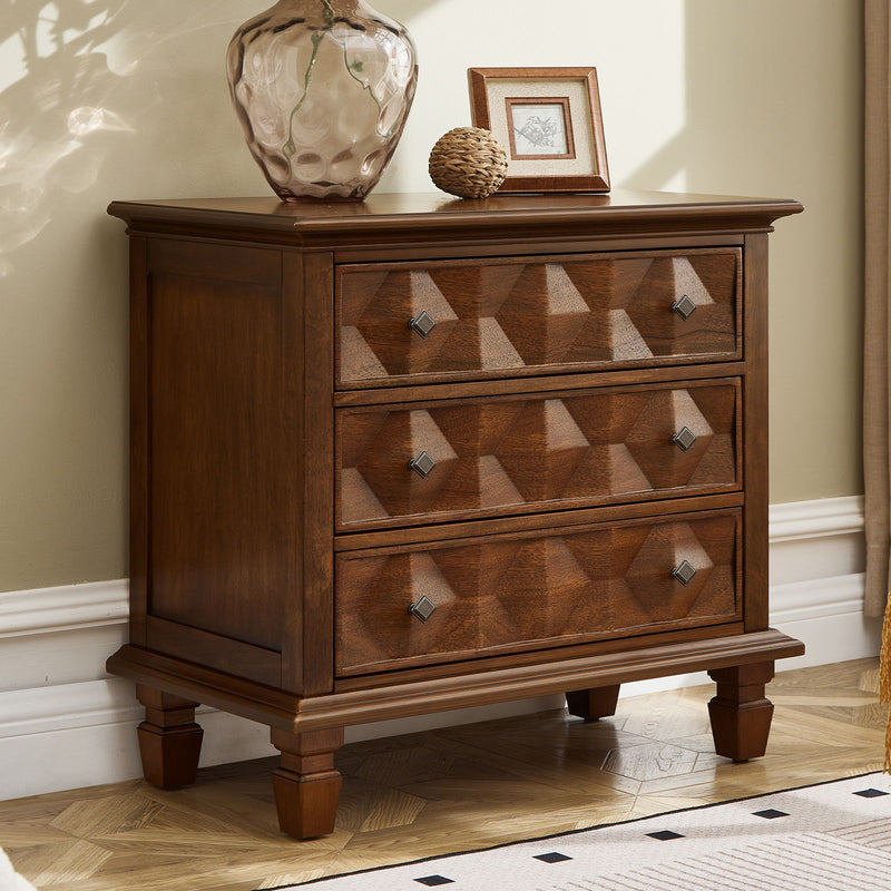 Walnut bedside table with three drawers, decorative fronts, and raised feet