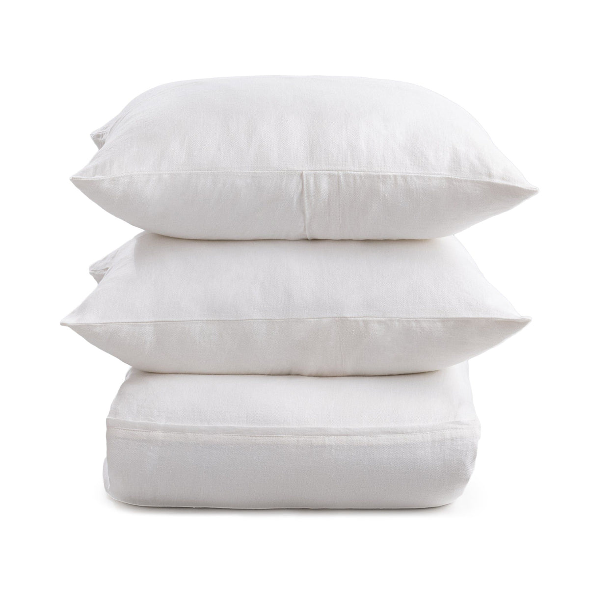 Cloud white pillow shams with envelope-style back closures, stacked for display
