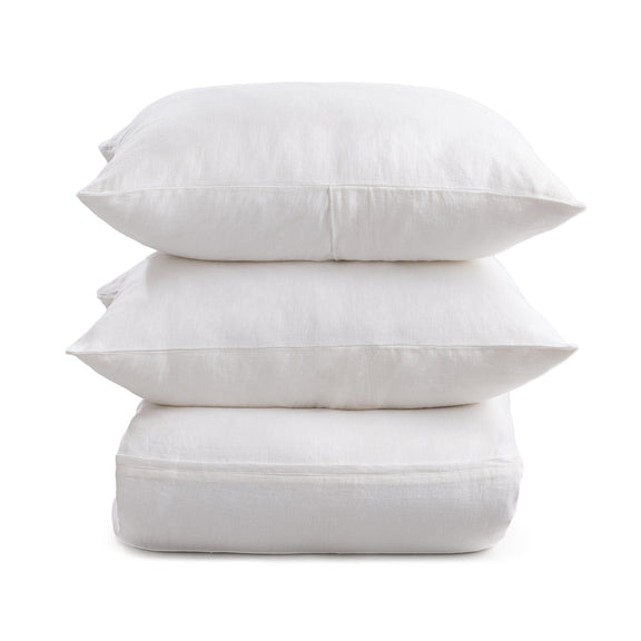 Cloud white pillow shams with envelope-style back closures, stacked for display