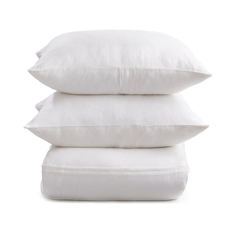 Cloud white pillow shams with envelope-style back closures, stacked for display
