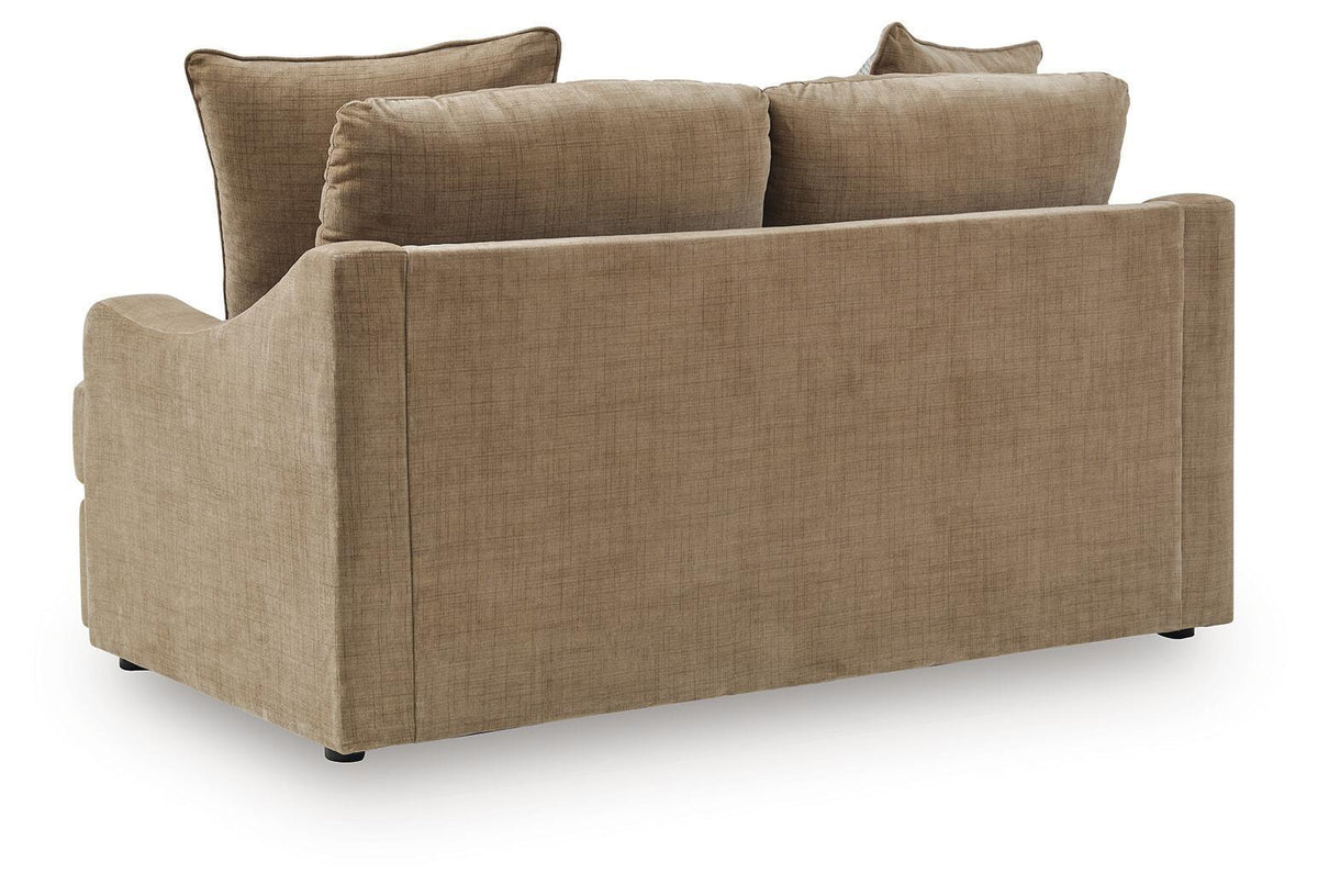 Beige upholstered loveseat with wide arms and back cushions