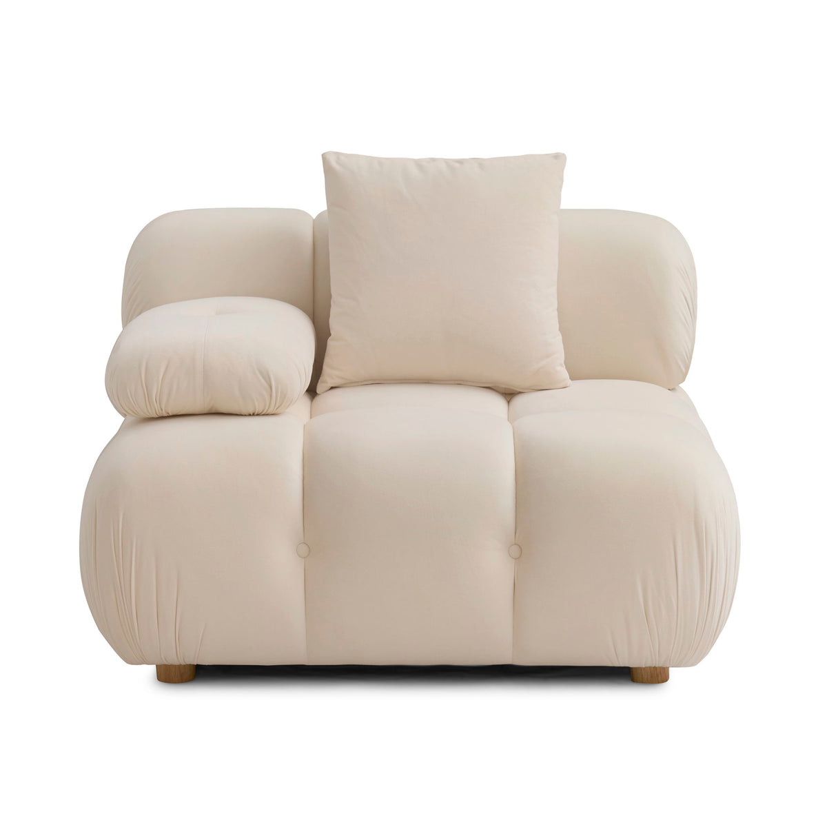 Cream corner chair with two pillows, padded armrests, and tufted seat sections
