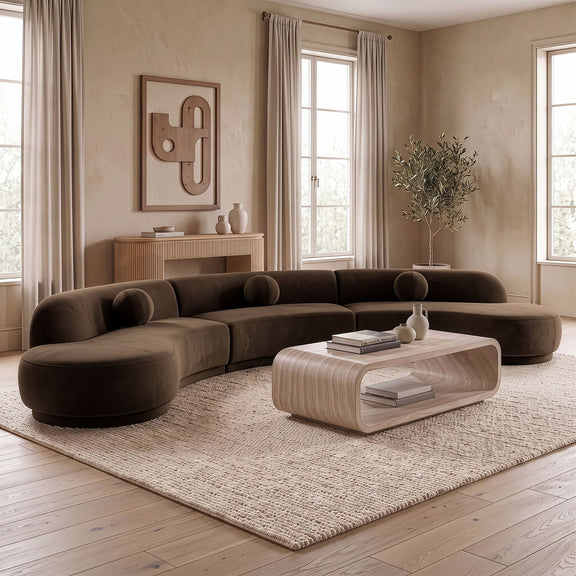 Dark brown velvet sectional with rounded chaise and deep cushioned seats
