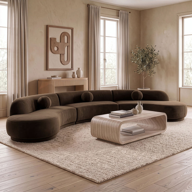 Dark brown velvet sectional with rounded chaise and deep cushioned seats
