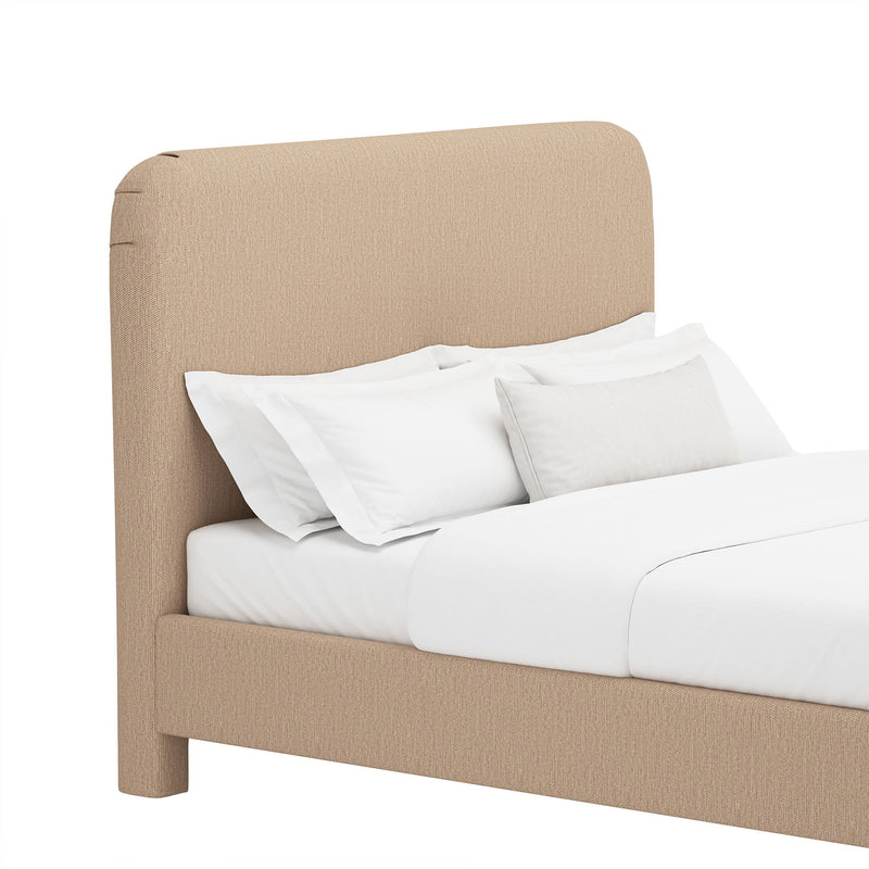Upholstered bed with rounded headboard and low foot, light brown fabric, white bedding