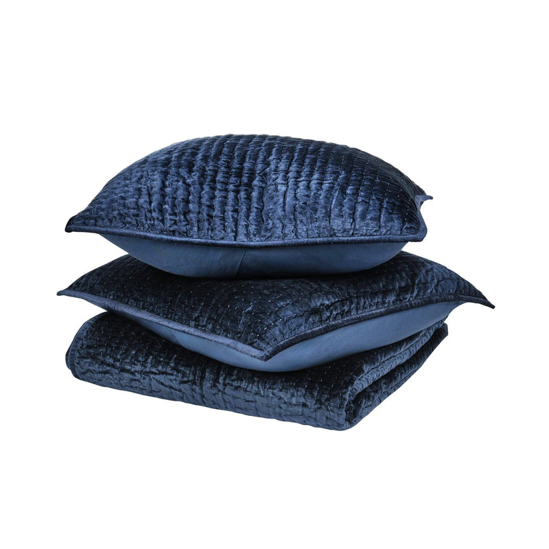 Navy velvet quilt with matching square throw pillows, stacked set
