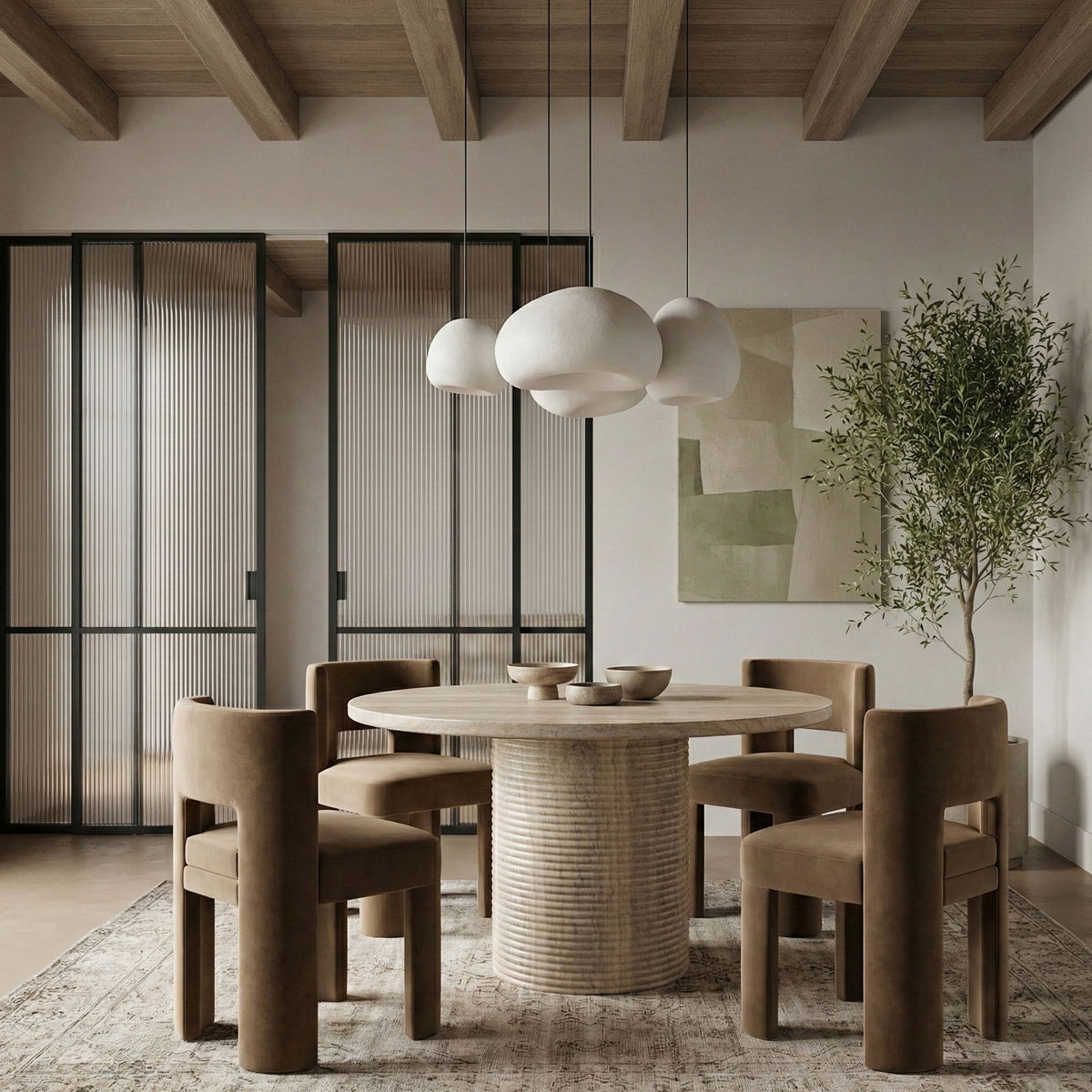 Round dining table with travertine-style top and ribbed cylindrical pedestal base
