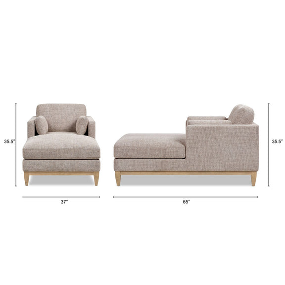 Light gray fabric chaise lounge chair with wide arms and front chaise ottoman
