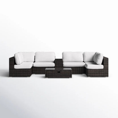 Dark brown wicker patio seating set with white cushions and glass-top table
