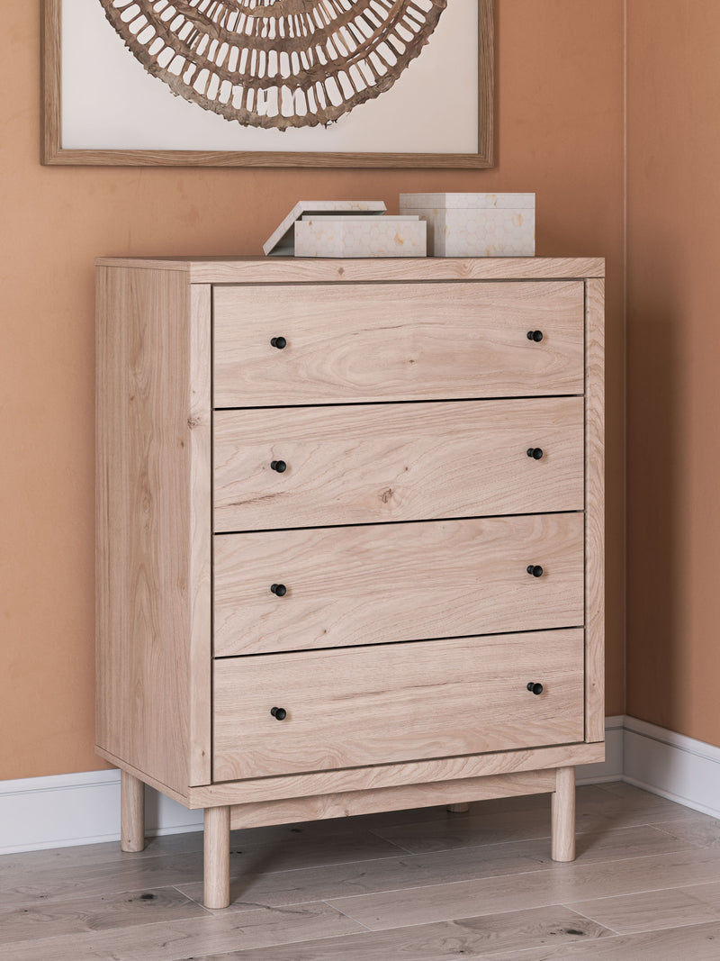Light wood four-drawer chest with three drawers and black round knobs