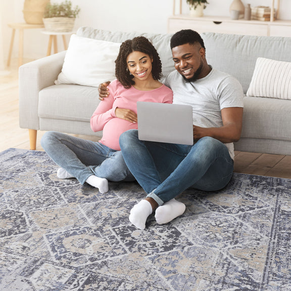 Gray and blue traditional area rug with distressed geometric pattern and textured finish