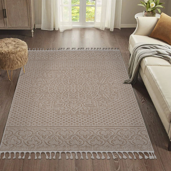 Beige medallion indoor/outdoor rug with ornate border, center medallion, and tassel fringe