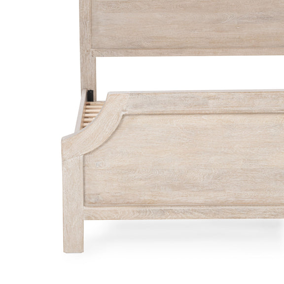 Solid wood bed footboard close-up with light wood finish and slatted panel