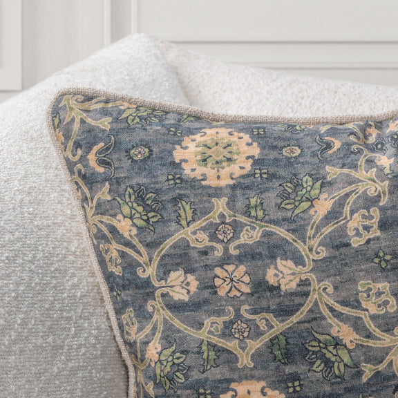 Close-up of blue-gray accent pillow fabric with cream and tan vine damask pattern