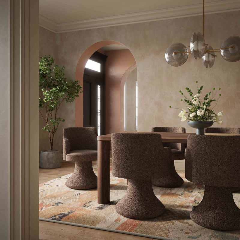 Dark brown boucle swivel dining chair in foreground, rounded back and pedestal base