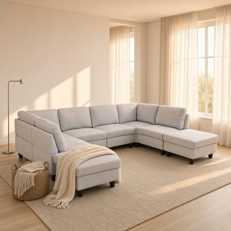 Light gray modular sectional sofa with U-shaped chaise and ottoman-style seat cushions