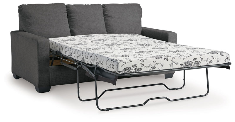 Dark gray sofa with pull-out bed frame and floral patterned mattress cover