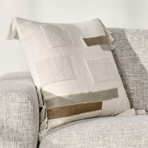 Packer ivory patchwork pillow with patterned panels and tassel accents