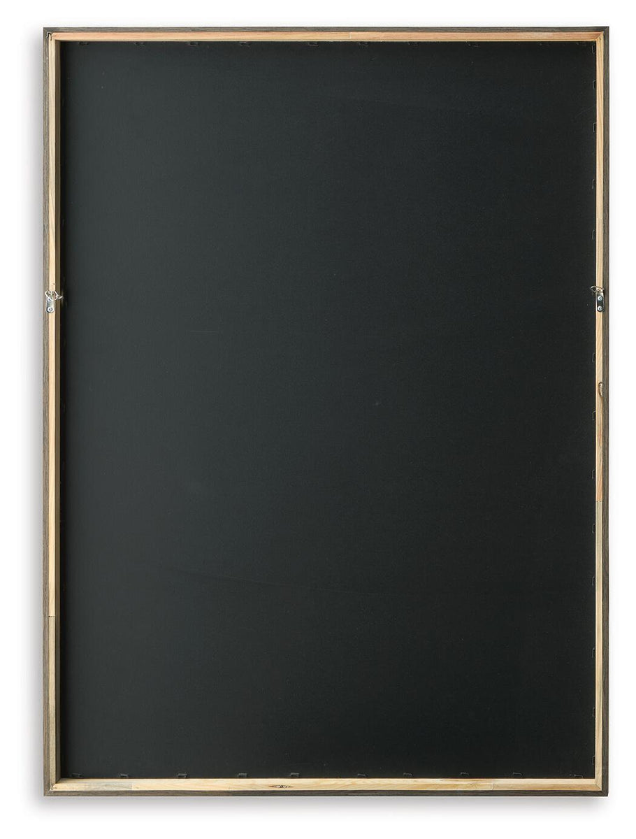 Backside of framed wall art with dark backing and gold-tone frame edges