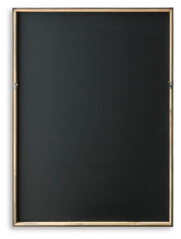 Backside of framed wall art with dark backing and gold-tone frame edges