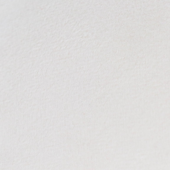 White textured pillow fabric, smooth close-up view.