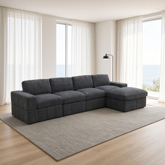 Dark gray modular sectional sofa with chaise ottomans on a light rug