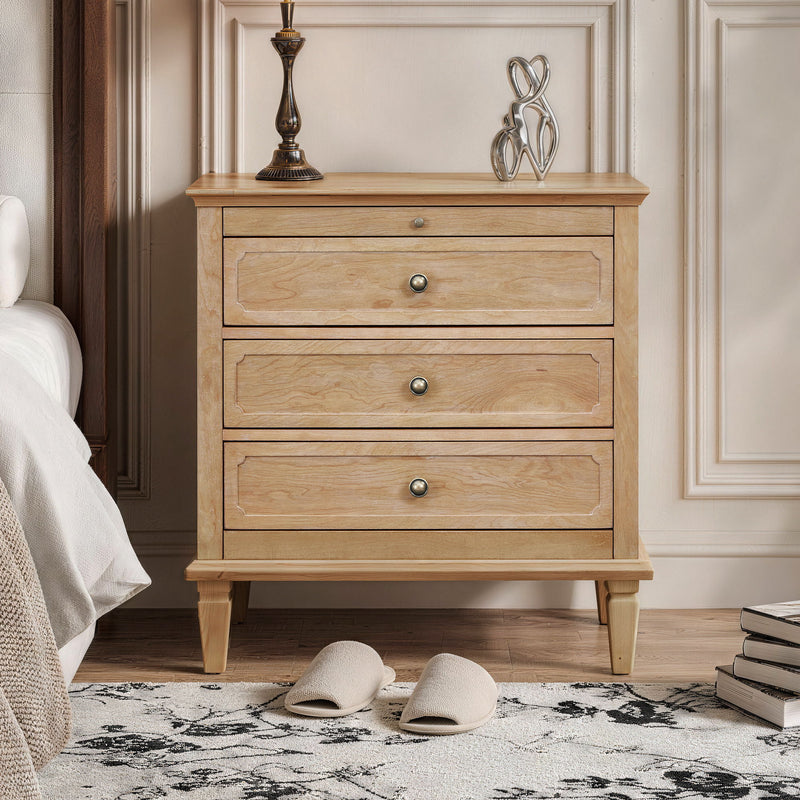 Light brown three-drawer nightstand with brass-tone knobs and tapered legs