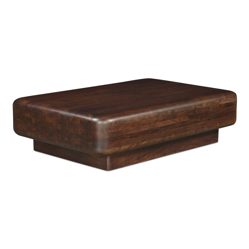 Angled view of the dark brown wooden coffee table, showing its thick top and low pedestal base.