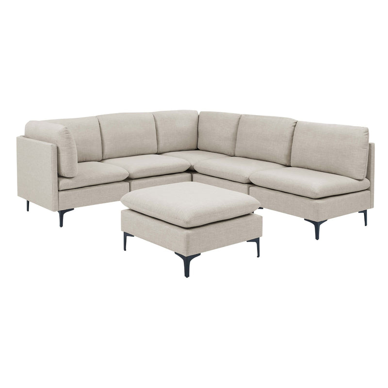 Beige modular sectional with tall legs and ottoman cube cushion in front