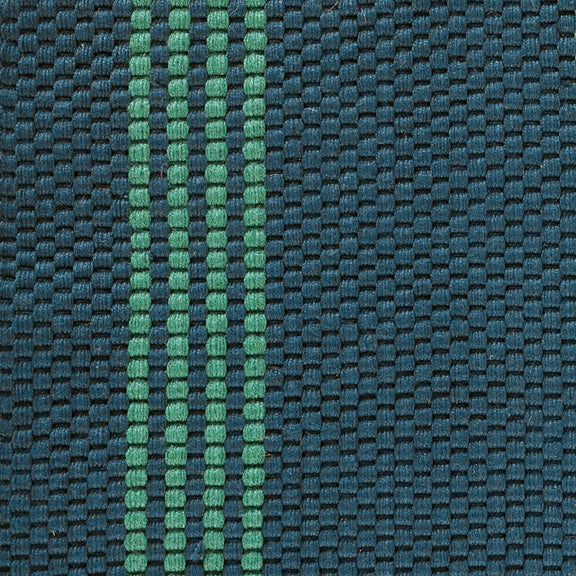Close-up of deep blue woven rug texture with green vertical stripe detail.