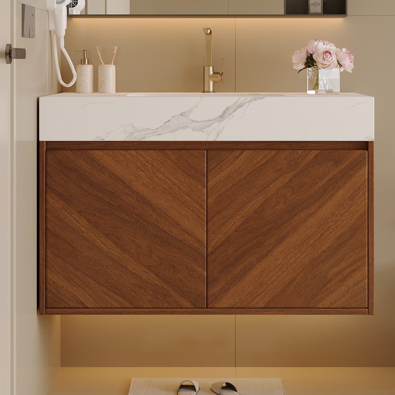 Front view of walnut vanity with two doors and a white marble-pattern sink