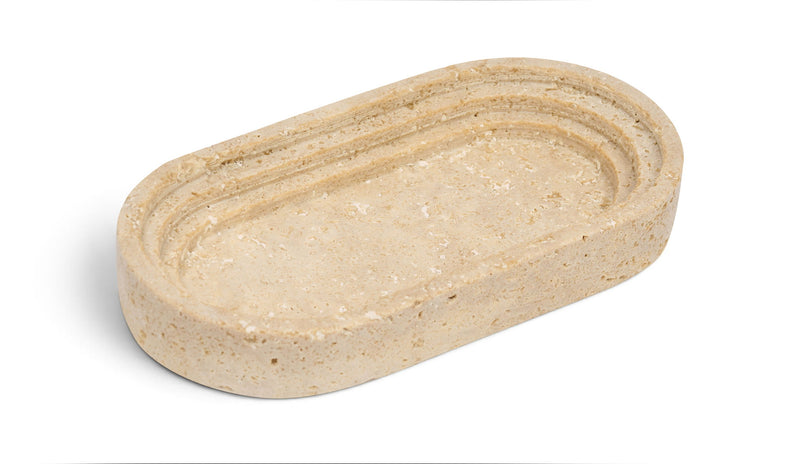 Travertine marble tray with oval shape and smooth rounded edges, beige with natural veining.