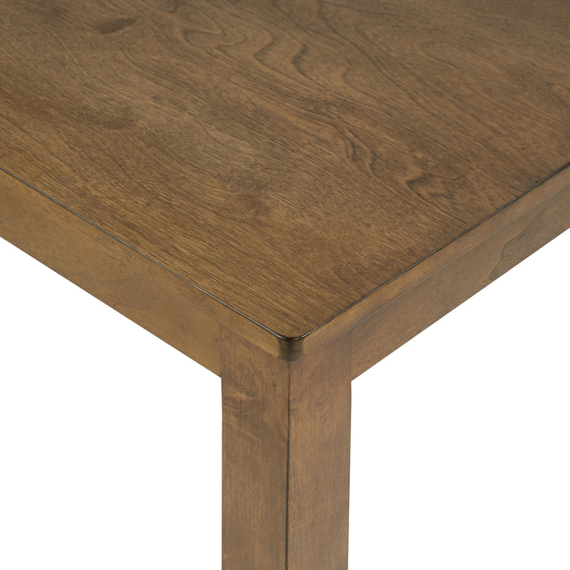 Oak dining table corner close-up with visible wood grain and rounded edge