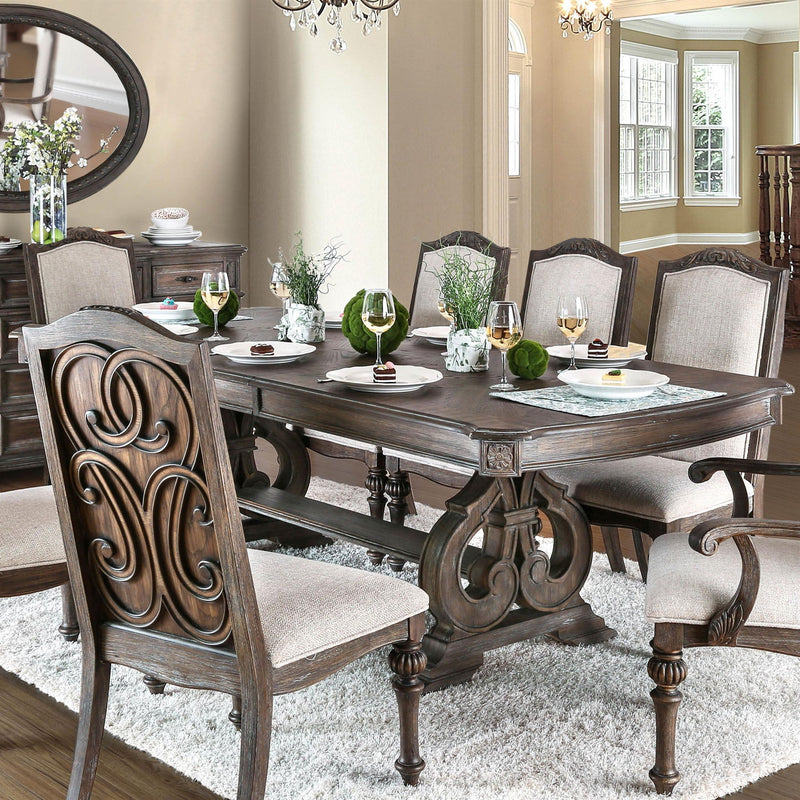 Rustic dining table with dark wood top and beige upholstered chairs