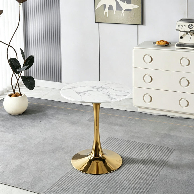 Round pedestal dining table with white marble-look top and gold pedestal base