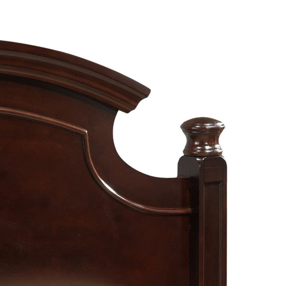 Dark brown carved bed headboard rail with curved cutout and turned post finial