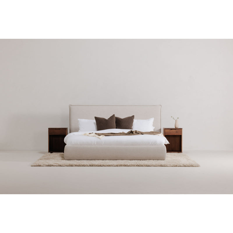 Wheat queen upholstered bed with tall headboard and decorative pillows