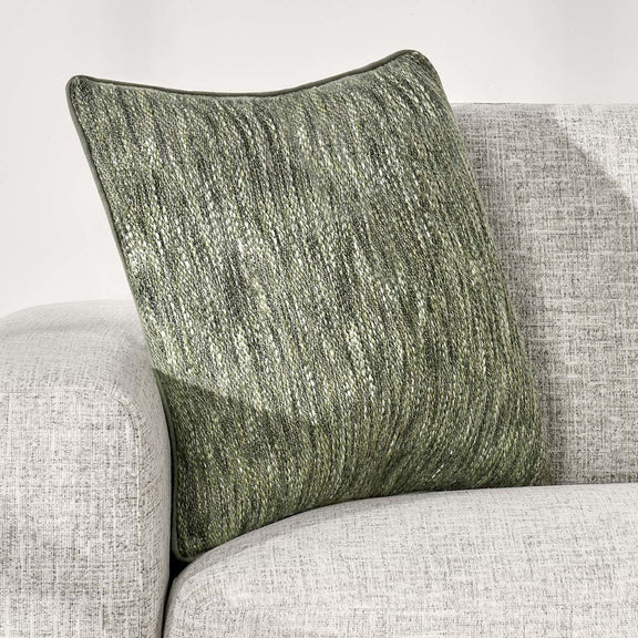 Cedar green linen-look square throw pillow angled on furniture, showing textured front