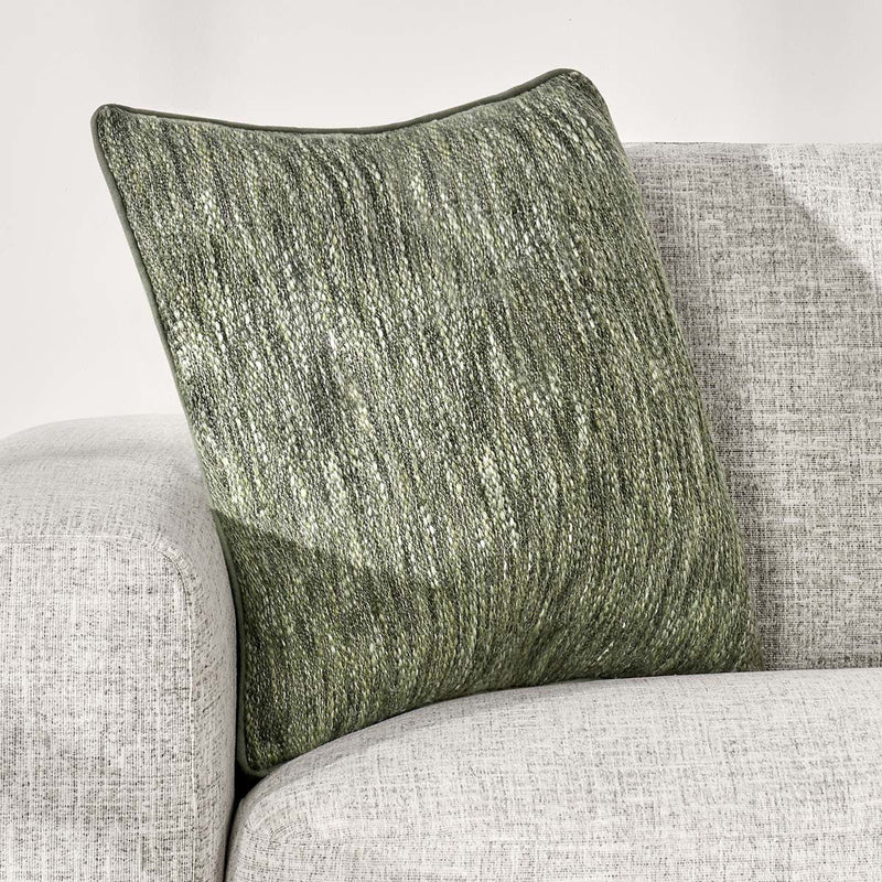 Cedar green linen-look square throw pillow angled on furniture, showing textured front